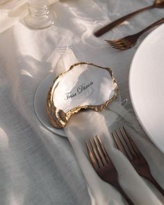 there is a place setting on the table with silverware and napkins in front of it