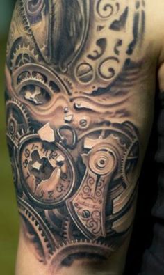 a man's arm with a clock and gears tattoo design on the left side of his arm