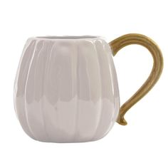 a white ceramic mug with gold handle