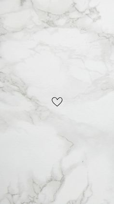 a white marble surface with a black heart drawn on the top and bottom part of it