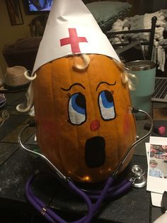 a pumpkin with a doctor's hat on top of it