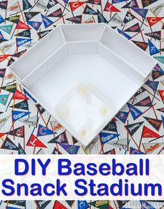 an empty baseball snack box sitting on top of a table covered in flags and pennants