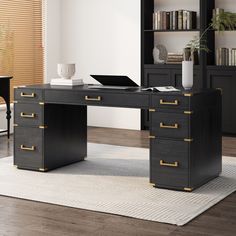 a black desk with gold handles in front of a bookcase and bookshelf