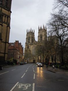 an empty street with cars parked on the side