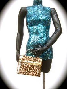 "Exotic leopard print pony hair box purse designed by Lisette New York PLEASE READ ENTIRE DESCRIPTION The stylish box purse is covered with animal print pony fur on all of the exterior sides Designed with gilt metal swivel handles & matching gold metal hardware trim. Lined in golden yellow cloth Labeled: Lisette New York Makes a very chic, eyecatching accessory Measurements The length from side to side measures 8\" inches The height from top of the lid to the base measures 6.25 in The drop l Box Purse, Artisan Necklace, Top Handle Bags, Pony Hair, Pig Skin, Polka Dot Blouse, Clothing Labels, Golden Yellow, Metal Hardware