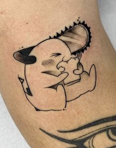 a tattoo on the leg of a man with a cartoon character holding an object in his hand