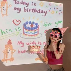 a girl with face paint holding a birthday cake in front of a sign that says today is my birthday