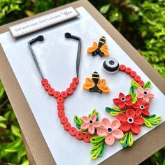 a card with buttons and flowers in the shape of stethoscopes on it