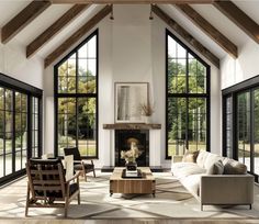 a living room filled with furniture and windows next to a fire place in front of a fireplace