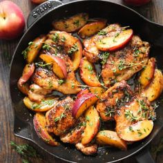 chicken and apples in a skillet with herbs