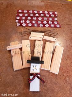 a paper doll made to look like a scarecrow with wooden pegs and clothes pins