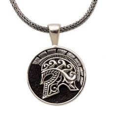 A circular pendant hangs from a chain featuring the image of a warrior's helmet. Handcrafted from sterling silver this men's pendant necklace is designed by Indonesia's Putu Gede Darmawan who draws inspiration from Hayam Wuruk known as the fourth king of the ancient Javanese kingdom of Majapahit. Mens Pendant Necklace Silver, Collectible Round Pendant Box Chain Jewelry, Warrior Style Engraved Pendant Jewelry, Engraved Warrior Style Pendant Jewelry, Silver Engraved Warrior Necklace, Warrior Style Engraved Sterling Silver Jewelry, Silver Warrior Style Necklace For Gift, Viking Style Sterling Silver Nickel-free Necklace, Viking Style Engraved Sterling Silver Jewelry