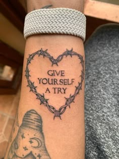 a person with a tattoo on their arm that says give yourself a try