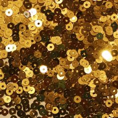 Round sequins with a center hole. 3000 sequins per pack. Sequins measure 3mm. Made in USA. Shiny metallic materials have a shiny metallic surface. They have a polished metal look and are a very traditional sequin material. The metallic sheen gives the material an almost ""mirror"" appearance. Size: 3 mm.  Color: Gold. Gold Theme Party, Drapery Trim, Black And Gold Theme, Sequin Flats, Bridal Applique, Jewel Colors, Gold Theme, Exterior Trim, Sequins Embroidery