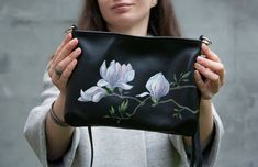 If you are looking for a unique black leather festive handbag, this is it! This small black purse is decorated with 100% hand-painted Magnolia flowers. Light pink Magnolia flowers look very beautiful. Pink flowers painting is made of acrylic paints. After drying, the drawing is fixed at high temperature. Therefore, it becomes resistant to moisture and abrasion. In every work of art I put a part of my soul, heart and emotional content. I really like my work, that's why every thing is so special a Magnolia Painting, Small Black Bag, Small Black Purse, Pink Magnolia, Magnolia Flowers, Black Leather Bag, Black Crossbody Purse, Women Crossbody Bag, Small Crossbody Purse