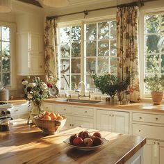 a bowl of fruit sitting on top of a wooden counter next to a sink in a kitchen