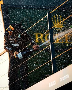 a man spraying water on the side of a building