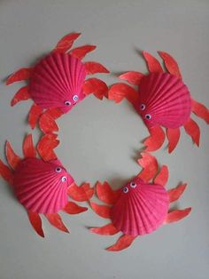 paper plates with red fish on them are arranged in the shape of a spiral frame