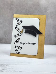 congratulations card with black and white graduation cap on top, gold border around the edges