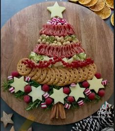 a christmas tree made out of pretzels and crackers on a cutting board