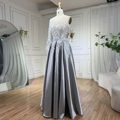 Chic grey satin fabric exudes sophistication and elegance, perfect for formal occasions. One-shoulder design adds a modern twist while providing an alluring silhouette. Handmade flowers adorn the gown, adding a delicate and feminine touch. A-line silhouette offers a timeless and flattering fit, suitable for various body types. Ideal for women seeking an elegant and stylish ensemble for formal events in 2025 . Crafted with meticulous attention to detail and high-quality materials for comfort and Gray Prom Evening Dress With Sweep Train, Gray Evening Dress With Sweep Train For Prom, Gray Sweep Train Prom Evening Dress, Gray Sweep Train Evening Dress For Prom, Gray Evening Dress For Prom Season Banquet, Gray Evening Dress For Prom Season, Gray Prom Evening Dress For Prom Season, Gray Evening Dress For Prom, Gray Evening Dress For Banquet And Prom Season