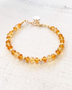 The stunning combination of sunny yellow and rich amber citrine creates a beautiful gemstone bracelet. This elegant piece is finished with luminous 14k gold-filled components. November's birthstone is nothing less than captivating. Bracelet length: 7.25 inches plus 1-inch extender Materials: 4-6 mm citrine faceted beads, 14 k gold-filled components Faceted Gold Crystal Bracelet, Elegant Adjustable Citrine Crystal Bracelet, Faceted Citrine Amber Jewelry, Amber Citrine Jewelry With Natural Stones, Elegant Amber Beaded Bracelets, Elegant Orange Beaded Bracelet With Natural Stones, Adjustable Citrine Yellow Gold Jewelry, Adjustable Gold Crystal Bracelet With Gemstone, Adjustable Yellow Gold Citrine Jewelry