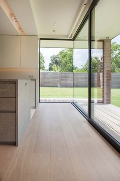 an empty kitchen with sliding glass doors leading outside