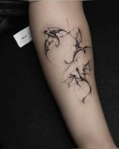 a woman's arm with an artistic tattoo design on the left side of her leg