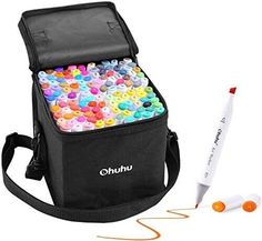 a black bag filled with lots of different colored buttons next to a marker and pen