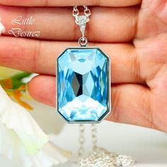 Cheap Personalized Blue Necklaces, Luxury Light Blue Necklaces For Anniversary, Luxury Light Blue Pendant Necklace, Cheap Light Blue Nickel-free Necklaces, Luxury Blue Rectangular Pendant Necklace, Luxury Light Blue Birthstone Jewelry, Luxury Blue Necklace With Rectangular Pendant, Mauve Earrings, Long Crystal Earrings