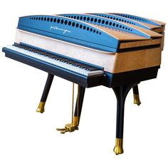 three blue and white pianos sitting side by side on top of each other with gold legs