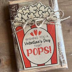 a valentine's day treat bag with popcorn tags on it and the words wishing you a valentine's day that pops