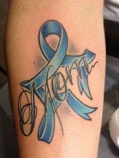 a blue ribbon with the word hope on it is sitting on someone's leg