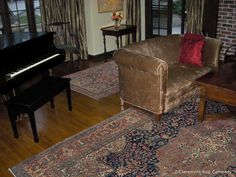 a living room filled with furniture and a piano