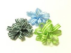 three different colored bows on a white background