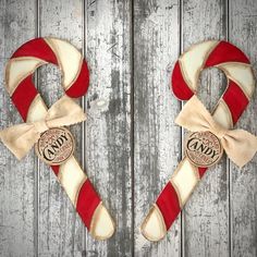 two red and white candy canes on top of a wooden table