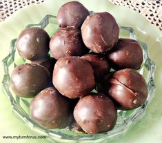 a glass bowl filled with chocolate candies on top of a table