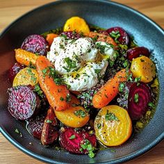 a bowl filled with carrots, beets and other vegetables on top of a wooden table