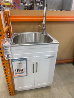 a stainless steel sink in a store with the price tag for $ 699 on it