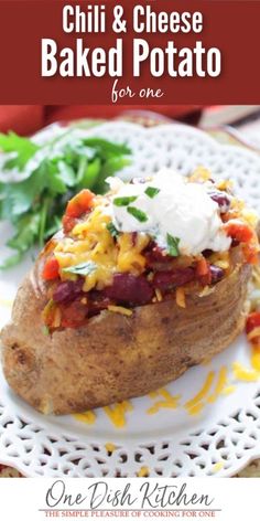 a baked potato topped with cheese and other toppings on top of a white plate