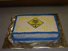 a sheet cake with blue and white frosting on it that says blue or gold pack 421