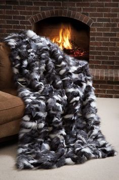 a blanket that is sitting in front of a fire place