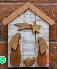 a wooden nativity scene with two men and a baby jesus