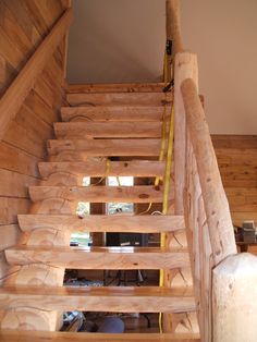 the stairs are made from wood and have yellow tape on them, along with other materials