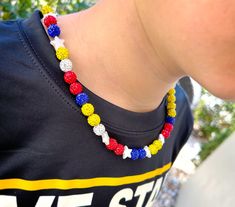 "Sports fan or player necklace made with rhinestone disco balls! These necklaces are very sparkly - lots of BLING! Venezuela flag colors with stars. Red, Yellow, White and Blue colors with Pearl White Star. This is a stretch necklace and does not have a clasp. Ends are tied off - NO METAL USED. Inspired by the necklaces Venezuelan pro ball players started wearing in the 2023 season.  **May not be ideal for kids who pull, tug, twist, or chew on necklaces** Necklace Length Options: - 16\" (popular for youth ages 7-10) - 18\" (popular for youth ages 9-14) - 20\" - 22\" - 24\" Bracelet Size Options: - Small = 6.25\" - MD/Large = 7.5\" - Need a custom Size? Message us! *Made with stretchy cord, ends tie, no clasp or metal. Some baseball leagues do not allow players to wear jewelry with metal. M Baseball Drip, Venezuela Flag, Baseball Necklace, Necklace With Pearl, Boy Diy, Diy Bracelet Designs, Cord Ends, Disco Balls, Ball Necklace