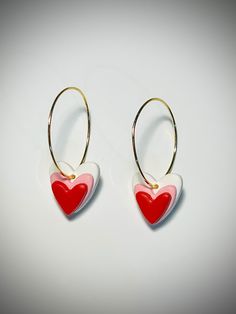 Red, white, and pink hearts on 18k gold plated hoop earrings | Polymer Clay Earrings. Easy to put on (see video!) and secure. Perfect for Valentine's Day, everyday wear, or that special occasion!  Super lightweight, durable, with hypoallergenic 18k gold plated hoops. Gift wrapping available. Each item will be similar, but not identical as all items are handmade with love in Knoxville, TN 🧡 Thank you for supporting my small business! Don't hesitate to reach out to me if you have questions or iss Small Hoop Yellow Gold Earrings For Valentine's Day, Pink Heart Charm Hoop Earrings For Valentine's Day, Pink Hoop Earrings With Heart Charm For Valentine's Day, Pink Huggie Heart Earrings For Valentine's Day, Pink Heart Huggie Earrings For Valentine's Day, Small Red Hypoallergenic Hoop Earrings, Pierced Huggie Earrings For Valentine's Day, Hypoallergenic Round Earrings For Valentine's Day, Valentine's Day Round Earrings With Ear Wire