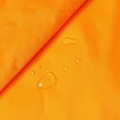 yellow fabric with water drops on it