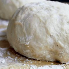 a ball of dough sitting on top of a wooden table