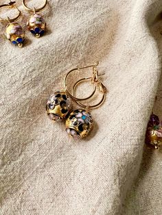 ✶ ✶ ✶ ~ Golden Belles collection ~ ✶ ✶ ✶  Vintage Chinese Champlevé cloisonné enamel earrings - oval gilt 1940s beads, 18k gold plated dangle hoop earrings, sustainable gift Stunning reworked earrings, using 1940s champlevé upcycled from a  vintage necklace, on new, 18k 18mm gold plated earring hoops - either 18mm larger hoops, or huggie hoops.  These have opulent royal vibes, with deep black, pink and blue enamel details.  Very limited edition.  Other cloisonné dangles available in my shop.  Pl Gold Enamel Hoop Jewelry, Gold Enamel Hoop Earrings, Gold Enamel Hoop Earrings Gift, Black Enamel Hoop Earrings For Gift, Black Enamel Hoop Earrings As Gift, Gold Hoop Earrings With Black Enamel For Gift, Nickel-free Enamel Round Hoop Earrings, Handmade Gold Enamel Earrings, Gold Enamel Earrings With Black Detail