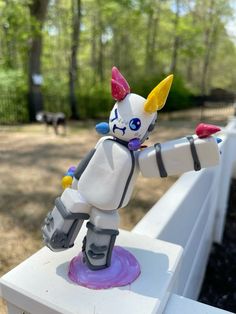 a toy is sitting on top of a white bench